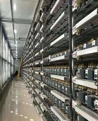 Rows and rows of mining rigs humming in a large warehouse.