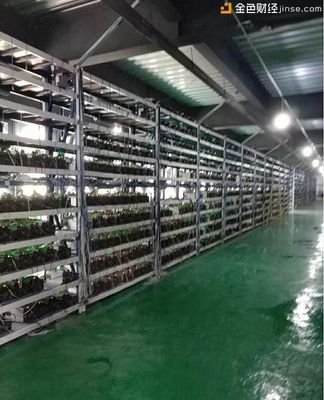 A large mining farm facility with rows of mining rigs